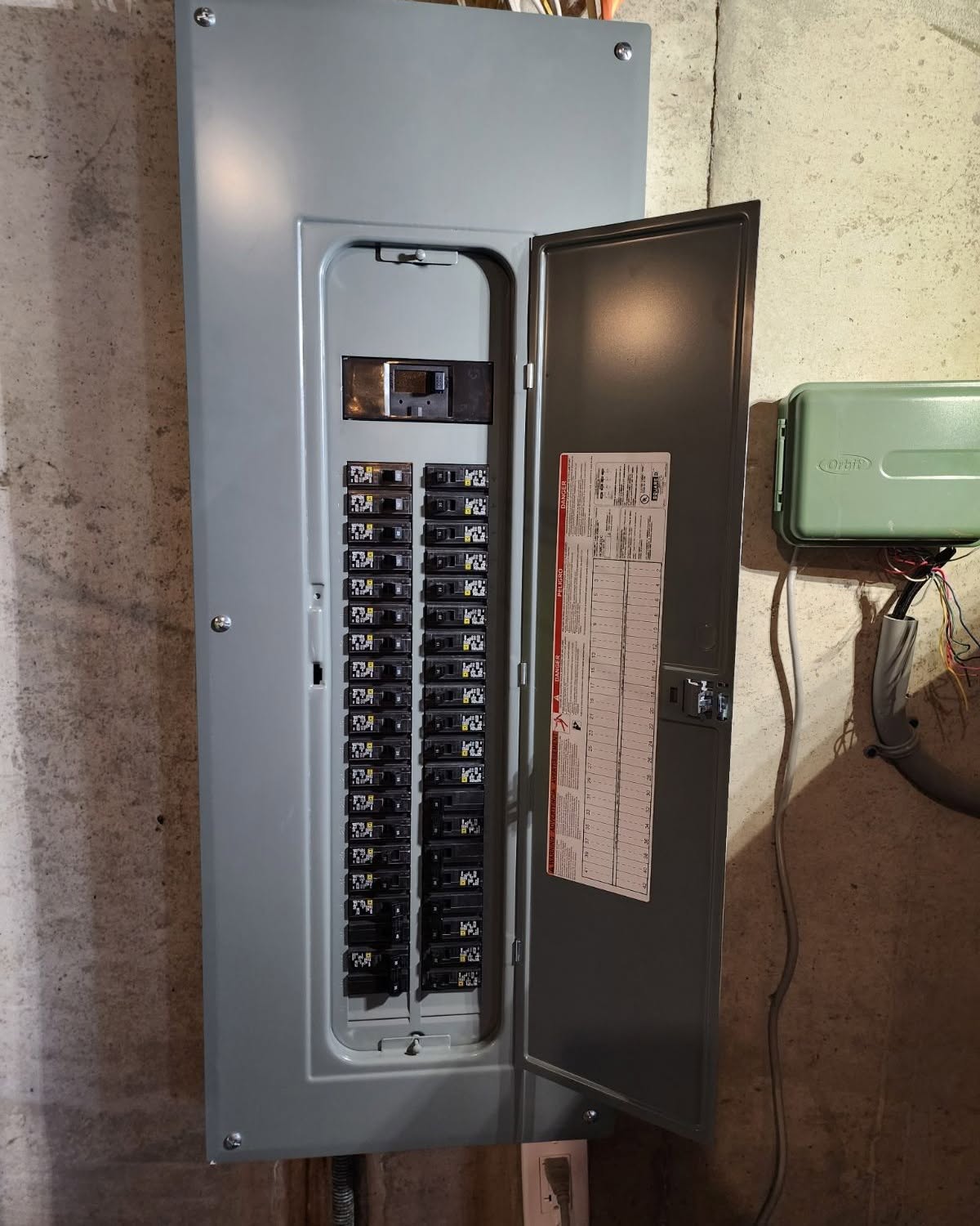 Technician working near residential electrical panels and wiring