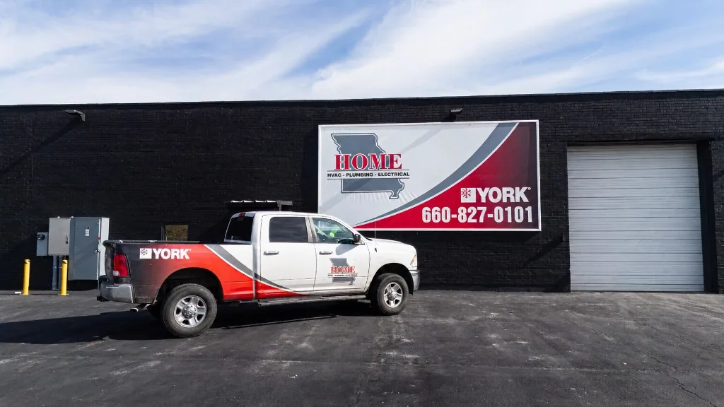Home HVAC, Plumbing & Electrical team gathered outside the Sedalia shop